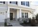 Close-up of the front porch, showcasing stone accents and a black front door at 110 Manor Stone Dr, Clayton, NC 27527