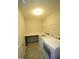 A functional laundry room is equipped with shelving, a countertop, and modern washer and dryer units at 110 Manor Stone Dr, Clayton, NC 27527