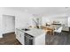 Open kitchen with granite countertops, stainless steel appliances, and hardwood floors at 1129 Sun Springs Rd, Wake Forest, NC 27587
