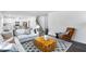 Stylish living room featuring hardwood floors, modern furniture, and a neutral color palette at 1129 Sun Springs Rd, Wake Forest, NC 27587