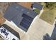 Aerial view showing a home with solar panels and detached garage on an expansive concrete driveway at 113 Valley Ln, Pittsboro, NC 27312