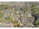 An aerial view of three homes in a serene woodland neighborhood at 113 Valley Ln, Pittsboro, NC 27312