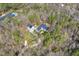 Aerial view of the home surrounded by a beautiful wooded landscape and nearby pool at 113 Valley Ln, Pittsboro, NC 27312