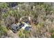 Drone shot of the home, RV parking, outdoor fireplace and circular driveway surrounded by woods at 113 Valley Ln, Pittsboro, NC 27312