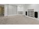 Open basement featuring white trim, carpet, and built-in shelves for storage or decoration at 113 Valley Ln, Pittsboro, NC 27312