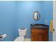 Powder room featuring blue walls, granite countertop, and custom mirror at 113 Valley Ln, Pittsboro, NC 27312