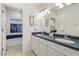 Bathroom featuring a double vanity, white cabinets, and a combined shower and tub at 113 Valley Ln, Pittsboro, NC 27312