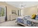 Bedroom with two twin beds, a ceiling fan, large windows, and neutral colored walls at 113 Valley Ln, Pittsboro, NC 27312