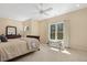 Bright bedroom with neutral walls, carpet and a large window overlooking a private, wooded lot at 113 Valley Ln, Pittsboro, NC 27312