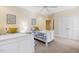 Bright bedroom featuring two twin beds, a ceiling fan, and an ensuite closet at 113 Valley Ln, Pittsboro, NC 27312