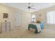 Well-lit bedroom features a ceiling fan, soft carpet, and a door to the exterior at 113 Valley Ln, Pittsboro, NC 27312