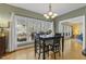 Dining area with a chandelier and large windows overlooking the backyard at 113 Valley Ln, Pittsboro, NC 27312