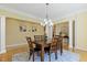 Bright dining room with hardwood floors, a stylish chandelier, and connections to other living spaces at 113 Valley Ln, Pittsboro, NC 27312