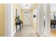 Inviting foyer featuring neutral tile floors, an accent table, and access to other rooms in the home at 113 Valley Ln, Pittsboro, NC 27312