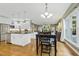 An open kitchen featuring white cabinetry, granite countertops, and stainless steel appliances at 113 Valley Ln, Pittsboro, NC 27312