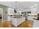 An open kitchen featuring white cabinetry, granite countertops, and stainless steel appliances at 113 Valley Ln, Pittsboro, NC 27312