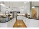 Kitchen with wooden floors, white cabinets, granite countertops, and stainless steel appliances at 113 Valley Ln, Pittsboro, NC 27312