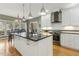 Bright kitchen with white cabinets, granite countertops, stainless steel appliances, and an island at 113 Valley Ln, Pittsboro, NC 27312