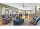 Bright living room with hardwood floors, cozy seating, and an open layout to the dining area at 113 Valley Ln, Pittsboro, NC 27312