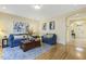 Cozy living room boasts hardwood floors, comfortable blue furniture, and seamless access to other living spaces at 113 Valley Ln, Pittsboro, NC 27312