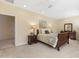 Comfortable main bedroom boasts soft carpet, an ensuite closet, and neutral walls at 113 Valley Ln, Pittsboro, NC 27312