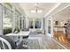 Light-filled sunroom with views of nature, a table and chairs, and access to the kitchen at 113 Valley Ln, Pittsboro, NC 27312