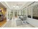 Relaxing sunroom with large windows, comfortable seating, and an entrance to the outdoors at 113 Valley Ln, Pittsboro, NC 27312