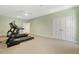 Workout room featuring carpet, ceiling fan, green walls, and workout equipment at 113 Valley Ln, Pittsboro, NC 27312