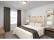 Well-lit bedroom featuring a cozy bed, neutral decor, and a view from the window at 1148 Centerview Drive, Nashville, NC 27856