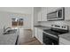 Modern kitchen featuring stainless steel appliances, granite countertops, and hardwood flooring at 1148 Centerview Drive, Nashville, NC 27856
