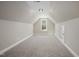 Spacious carpeted attic with natural light, ceiling light, and neutral paint at 115 S Harper Faith Way, Benson, NC 27504