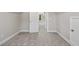Light-filled attic with neutral carpet, white trim, and access to other rooms at 115 S Harper Faith Way, Benson, NC 27504