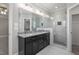 Modern bathroom with granite counters, dual sinks, frameless glass shower, and tile flooring at 115 S Harper Faith Way, Benson, NC 27504