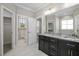 This bathroom boasts a double vanity, granite countertops, tile floors, and modern fixtures at 115 S Harper Faith Way, Benson, NC 27504