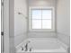 The bathroom features a soaking tub with ceramic tile and a chrome faucet at 115 S Harper Faith Way, Benson, NC 27504