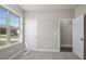 Bedroom features neutral carpet and paint, as well as white trim and a window overlooking a neighborhood at 115 S Harper Faith Way, Benson, NC 27504