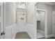Bright foyer featuring wainscoting, wood floors, and a view to the laundry room at 115 S Harper Faith Way, Benson, NC 27504