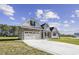 Beautiful home with two car garage, stone accents, and a long driveway at 115 S Harper Faith Way, Benson, NC 27504