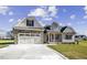 Charming home with a two-car garage, stone accents, and inviting front porch at 115 S Harper Faith Way, Benson, NC 27504
