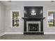 Granite fireplace with dark wood mantle and gas logs at 115 S Harper Faith Way, Benson, NC 27504