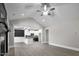Open-concept living room flows into kitchen with hardwood floors and vaulted ceilings at 115 S Harper Faith Way, Benson, NC 27504
