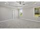 Main bedroom features neutral carpet and paint, and a trey ceiling with a ceiling fan at 115 S Harper Faith Way, Benson, NC 27504