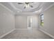 Main bedroom featuring neutral carpet and paint, and a trey ceiling with a ceiling fan at 115 S Harper Faith Way, Benson, NC 27504
