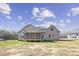 Neutral colored home with a rear screened-in porch in a quiet location at 115 S Harper Faith Way, Benson, NC 27504