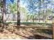 Backyard view with a wooden fence and lake in the background, offering a serene environment at 116 Lakeshore Dr, Durham, NC 27713