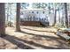Backyard with a deck, wooded area, picnic table, and outdoor seating, ideal for gatherings at 116 Lakeshore Dr, Durham, NC 27713