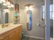 Bathroom with wooden vanity, shelves, mirrors, and a window, providing a bright and functional space at 116 Lakeshore Dr, Durham, NC 27713