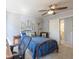 Well-lit bedroom with a bed, cactus decor, chair, and view to an adjacent bathroom, creating a comfortable space at 116 Lakeshore Dr, Durham, NC 27713