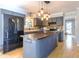 Stylish kitchen with a large island, modern lighting, and black appliances at 116 Lakeshore Dr, Durham, NC 27713