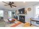 Bright living room featuring a fireplace, ceiling fan, and hardwood floors at 116 Lakeshore Dr, Durham, NC 27713